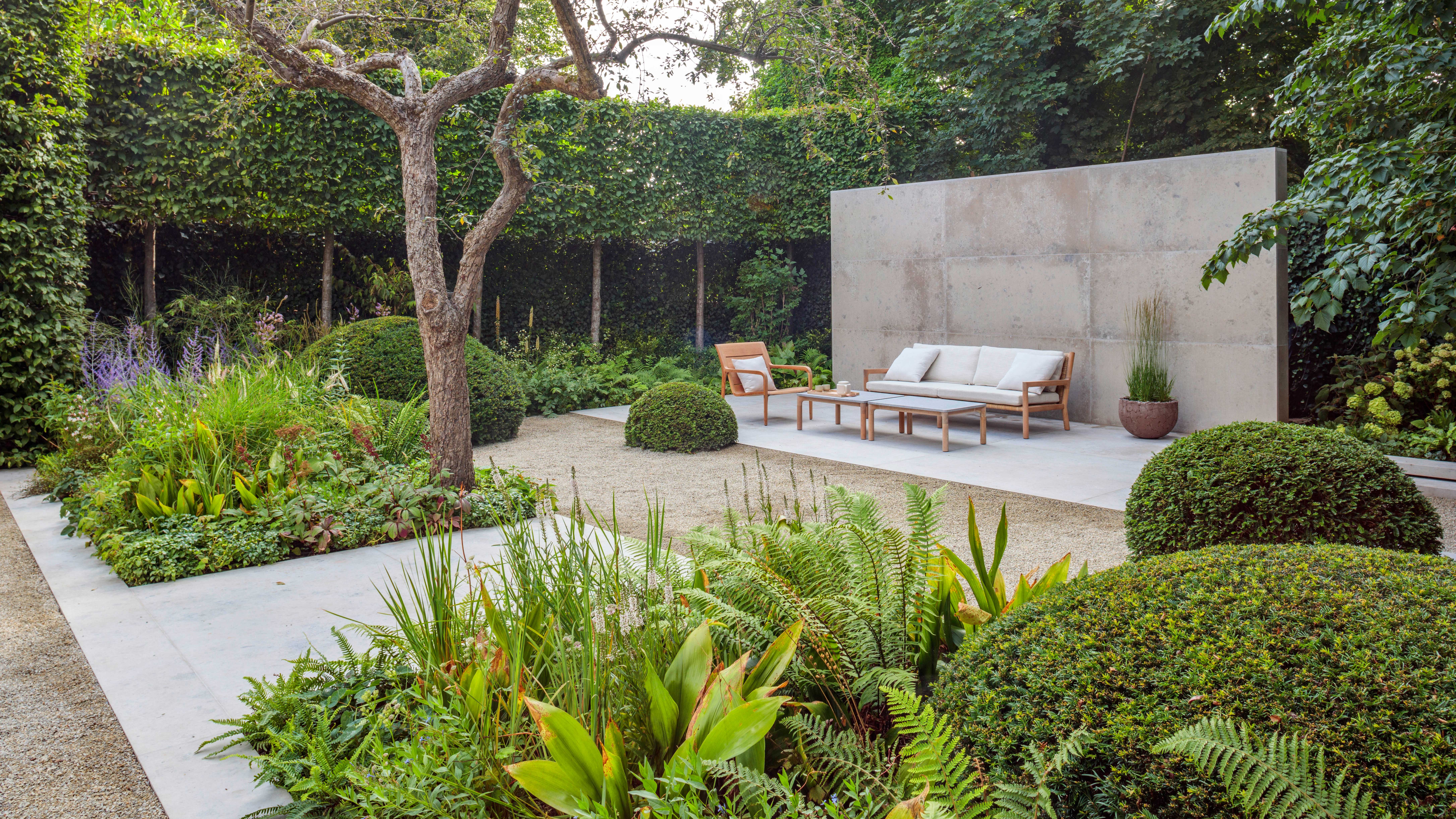 NatureForm landscaped garden with layered planting and a welcoming outdoor seating area