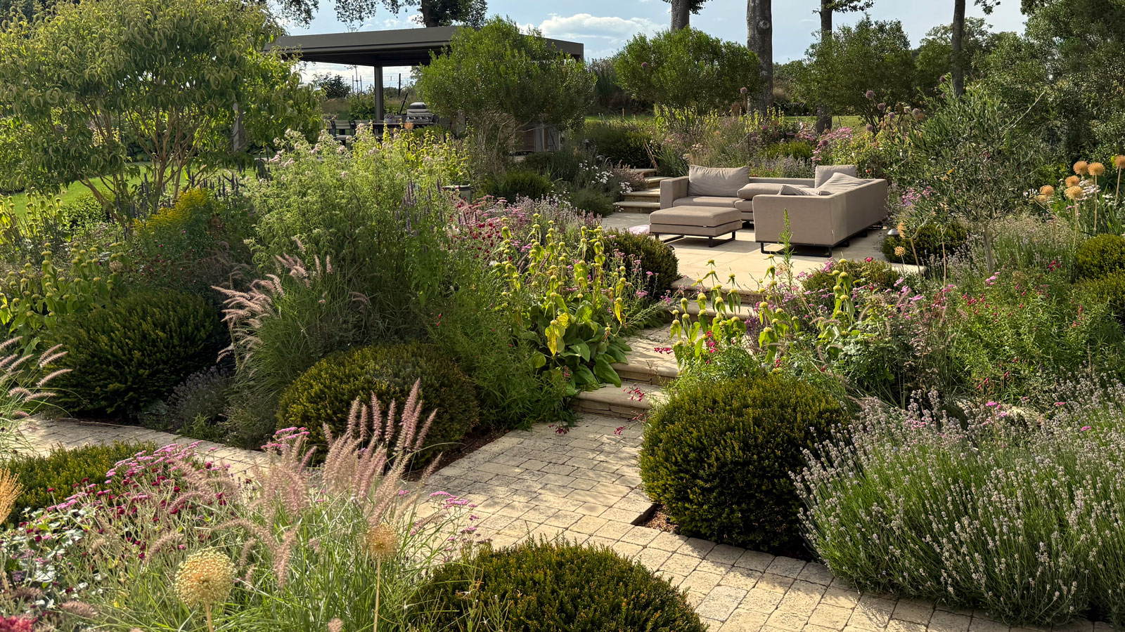NatureForm landscape design team reviewing garden plans outdoors